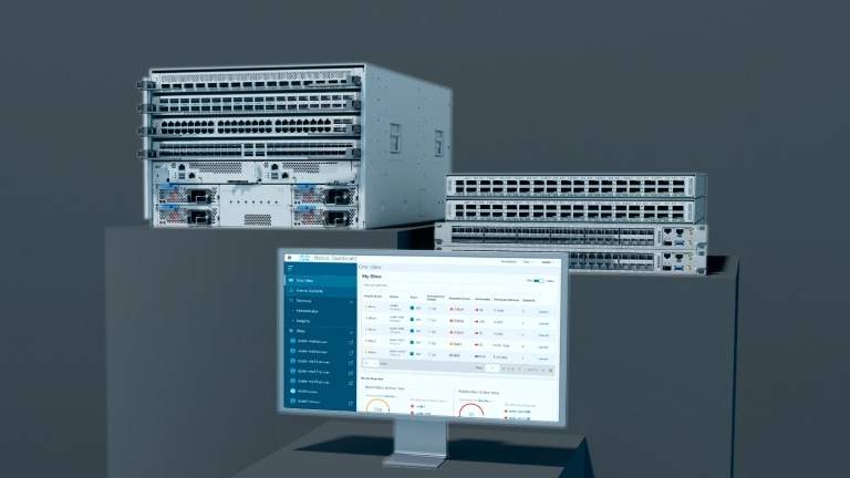 Cisco modular and fixed-configuration switches alongside a monitor displaying the Nexus Dashboard interface.