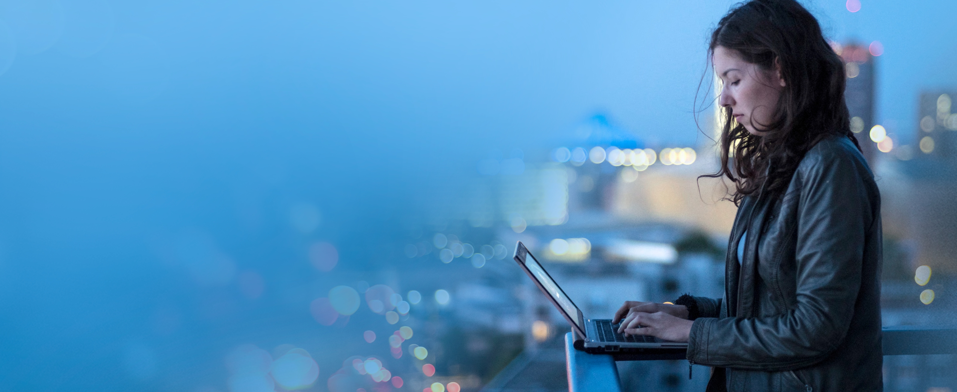 A person standing and working on Laptop