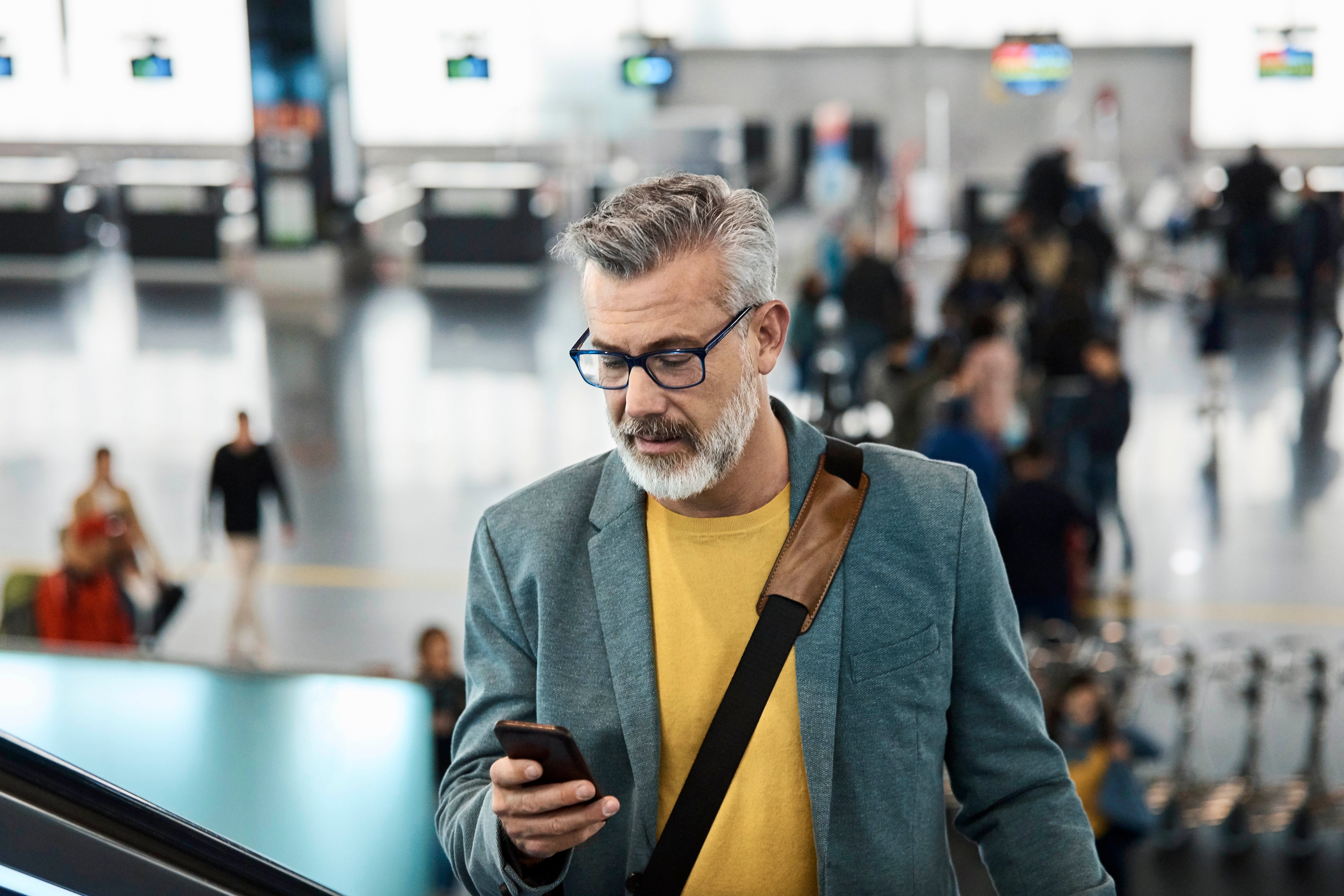 Man is on phone inside transportation terminal