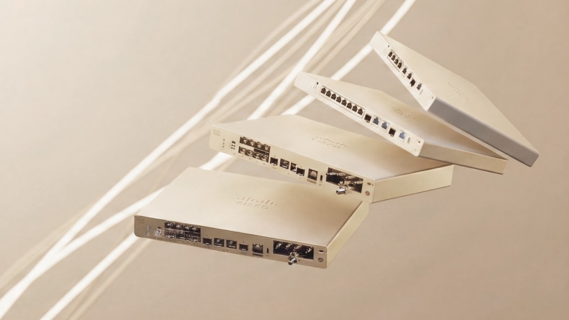 Four Cisco networking devices arranged in an expanded stack, displaying ports and the Cisco logo.